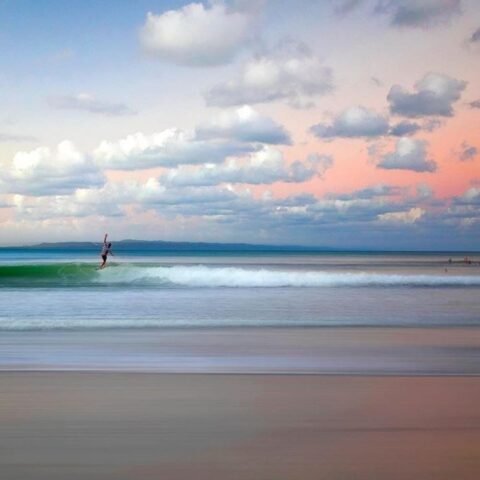 Surfing at sunset at Noosa Main Beach